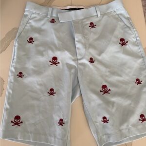 G/FORE light blue golf shorts with burgundy skulls